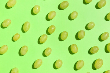 Tasty green grapes on color background