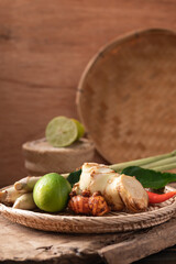 Thai food ingredients, Organic fresh spices and herbs in a bamboo basket on wooden
