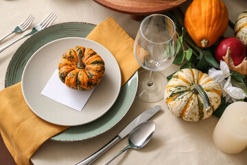Autumn table setting with fresh pumpkins, closeup