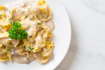 tortellini pasta with mushroom cream sauce and cheese