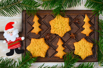 cooking a delicious festive homemade cookies or bisquits shaped christmas tree and snowflake, a sweet treat for christmas holiday, xmas theme and new year baking, funny kids food serving
