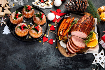 Christmas dinner table setting on dark background.