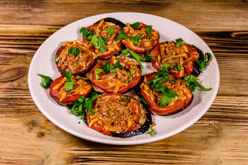 Baked eggplants with tomatoes and cheese in a ceramic plate