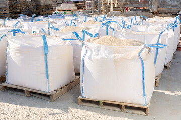 Close-up of full open bags of building mix for wall decoration at hardware store warehouse