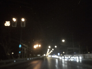 drunk vision on road, view form the car are blur lighting, Traffic light is blur in night time,