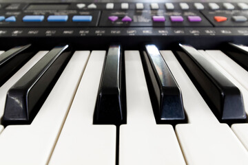 Black and white piano keys close up.