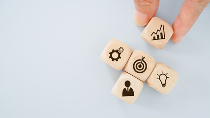 hand holding wooden cube with graph icon for brainstorming , target ,goal, coworker concept