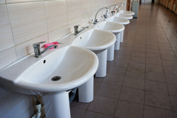 Close-up Of Washbasins In Row in public place