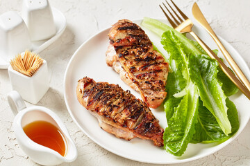 seared chicken breasts with romaine lettuce leaves