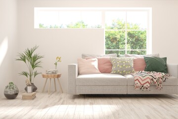 White living room with sofa and summer landscape in window. Scandinavian interior design. 3D illustration
