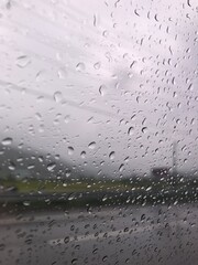 Raindrops falling on the window on a rainy day