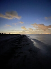 sun rising over the beach in Florida near the lighthouse