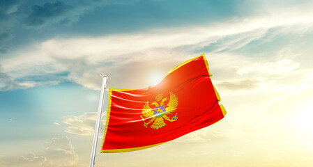 Montenegro national flag cloth fabric waving on the sky - Image