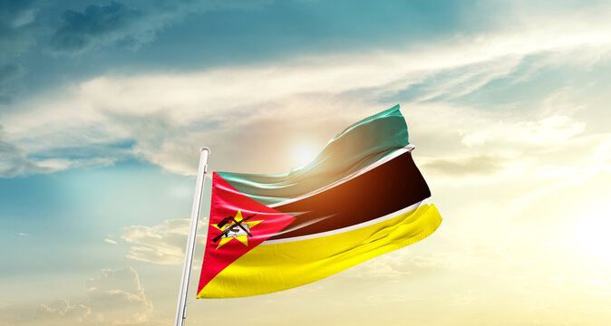 Mozambique national flag cloth fabric waving on the sky - Image