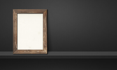 Wooden picture frame leaning on a black shelf. 3d illustration. Horizontal banner