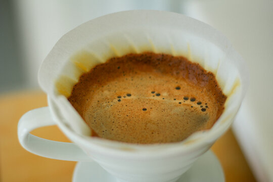 coffee brewing in a white ceramic pour over 