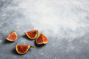 Pieces of figs on a gray background.