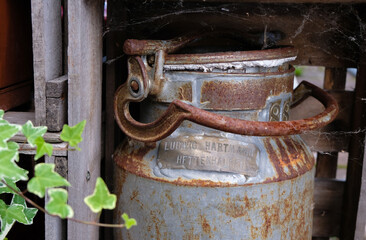 Antique milk can. Can number, owner's name, and community name on a metal card.