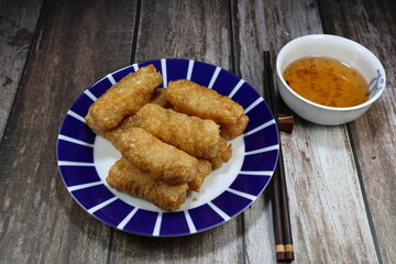 Pile of deep fried tofu sheet wrapped with fresh shrimp serving on the plate. Famous dim sum menu in Asia restaurant. 