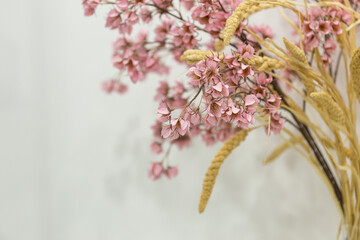 pink artificial flowers, a bouquet of silk flowers on a table on a white background
