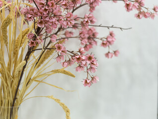 pink artificial flowers, a bouquet of silk flowers on a table on a white background
