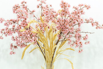 pink artificial flowers, a bouquet of silk flowers on a table on a white background