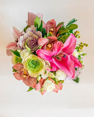 various colorful flowers bouquet top view closeup on white background