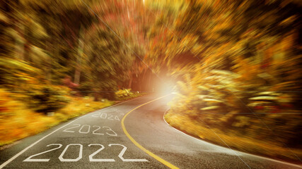 Motion blur The long road to the natural forest is labeled 2022, 2323, 2024, 2025. Happy New Year...