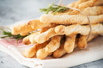 Italian grissini breadsticks with herbs and sesame seeds, selective focus