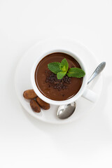 cup with hot mint chocolate on white table, top view vertical