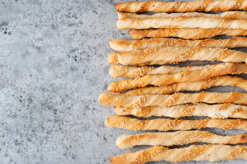 Italian grissini breadsticks with herbs and sesame seeds, top view