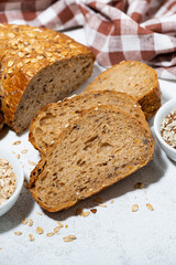 fresh bread with oatmeal and seeds, vertical