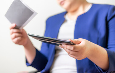 Business women with laptop and salary slip on brurred background