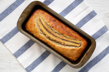 Homemade Banana Bread on a white wooden surface, top view. Flat lay, overhead, from above.