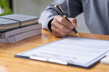 man hand signing a contract, Salesmen are letting the male customers sign the sales contract, Asian men doing business in the office, Business concept and contract signing