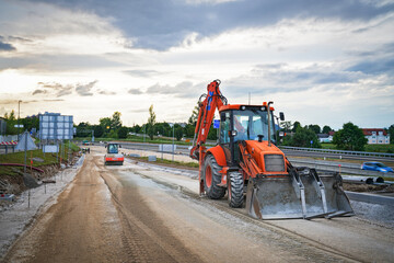 Wheel loader road roller in process of asphalting and paving road construction and repairing works