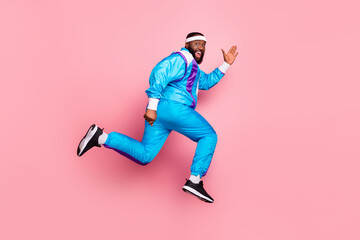 Fototapeta na wymiar Full body profile side photo of young black man happy positive smile go walk run jump isolated over pink color background