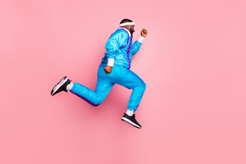 Fototapeta na wymiar Full size profile side photo of young black sportsman go walk run fast hurry jump isolated over pink color background