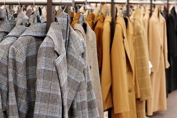 Female coats in a row on a hanger in the store. New autumn fashion collection