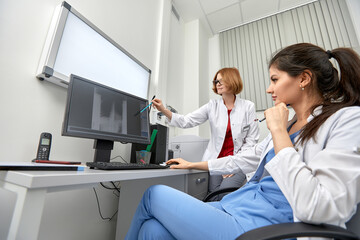 Fototapeta premium medical team discussing around a computer. Health care