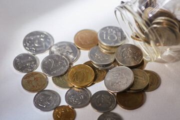The money of the country of Russia is poured out of a glass jar. The concept of business income.