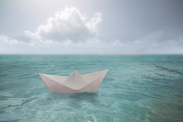 surreal paper boat travels alone in the infinite ocean