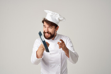 a man in a chef's uniform with a frying pan in hand isolated background