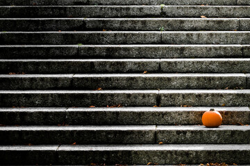 orange pumpkin on the black and white stairs