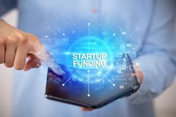 Businessman holding a foldable smartphone, new business concept