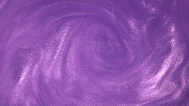 Purple glitter abstract background. Shiny liquid purple paint flows slowly onto the surface. Holidays, new year, fashion, abstract art concept video