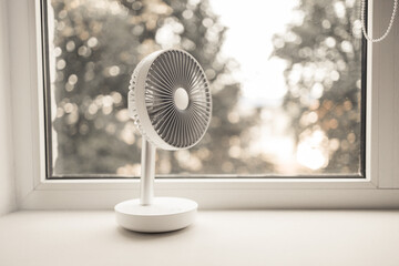 Fototapeta Modern electric portable fan in bedroom. Cooling of high air temperature. Minimal style, copy space. obraz