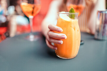 Close up view of female hand holding a glass of
