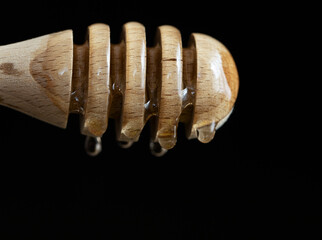 honey dripping from a stick