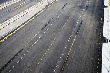 Road with white and yellow lines on a new asphalt